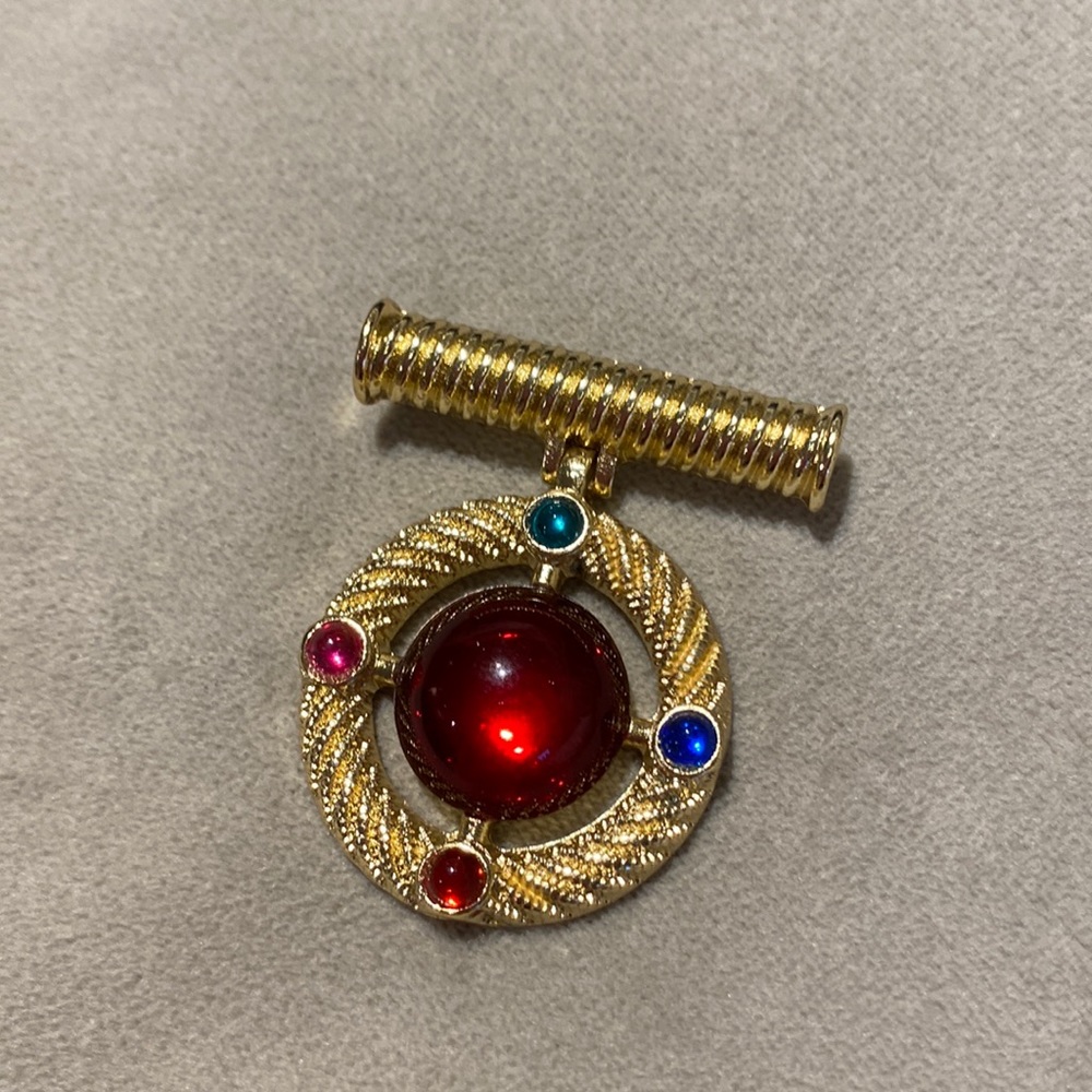 Vintage brooch with colorful glass